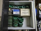 a shelf with a bunch of green hoses and other items