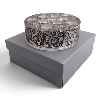 an image of a silver box with a decorative design on it