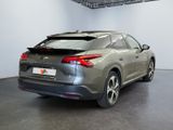 the rear end of a silver car parked in a garage