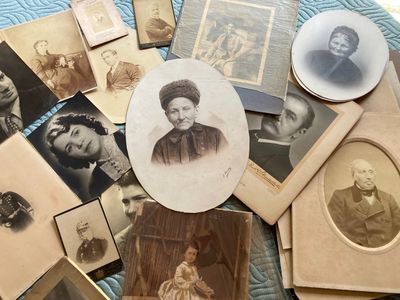 many old photos of women and men on the table