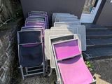 a lot of lawn chairs that are outside of a building