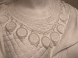 a statue of a woman with a necklace on her neck