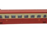an image of a red and beige train car
