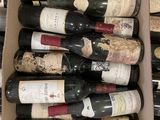 many bottles of wine in a box on the table