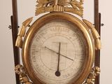 a clock that is on a stand with a clock on it