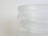 a glass vase with a flower decoration on it
