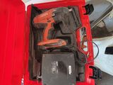 une boîte rouge contenant des outils, posée sur une table