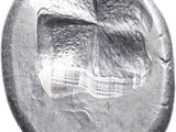 a close up of a silver coin with a cross on it