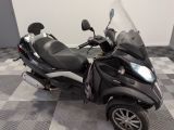 a scooter that is parked on a checkered floor