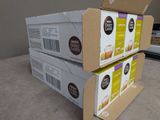 three boxes of coffee sit on top of each other on a table
