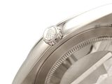 a close up of a watch on a white surface