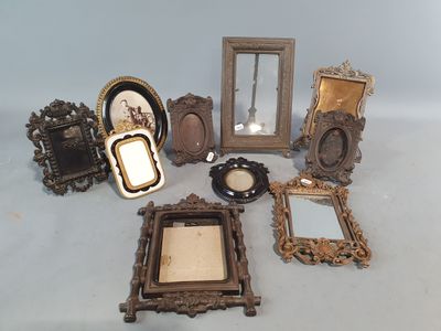 beaucoup de cadres et de miroirs anciens posés sur la table