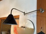 a light that is on the wall next to a mirror