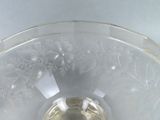 a clear glass bowl with a flower design on it