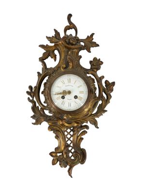 an image of a gold clock with a white face on a white background