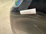 a sticker on the hood of a car that is parked in a parking lot