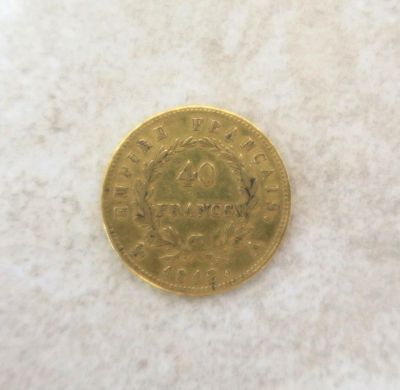a close up of a gold coin on a white surface