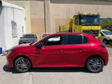 a red car parked in a parking lot with a truck in the background