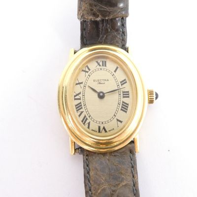 a gold wrist watch with roman numerals on it