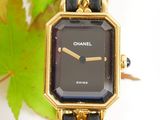 a black and gold watch with a chain around it
