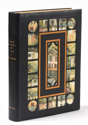 an old book with a picture of a house and a picture of a building