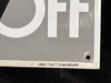 a sign that says off on the side of a building