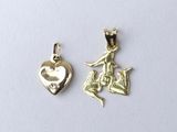 a close up of two charms on a white surface