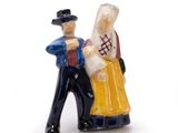 a figurine of a man and a woman holding hands