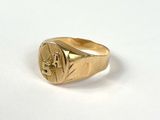 a close up of a gold signet ring on a white surface