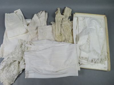 a lot of white laces on a table next to a box