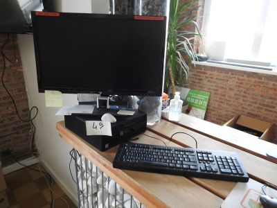 a keyboard and a monitor on a desk in a room