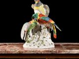 a figurine of two birds sitting on top of a table
