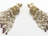 pair of earrings with pearls and garnets on a white background