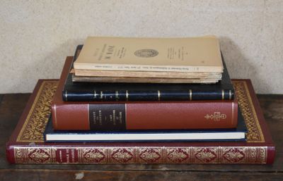 three books stacked on top of each other on a table