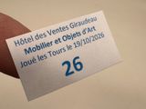 a hand holding a business card with the number 26 on it