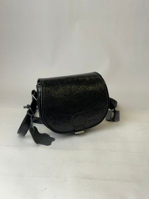 a black leather bag with a tassel hanging from it ' s side