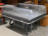 a table with a glass case on it in a room