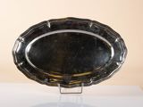 a silver platter on a stand on a table