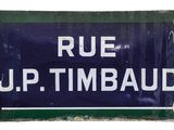 a blue and white sign that says rue up timbaud