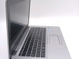 a close up of a laptop computer on a white surface