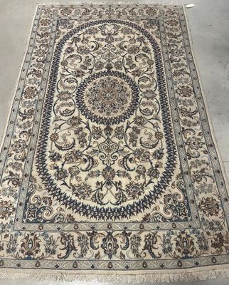 a large oriental rug with a floral design on a white ground