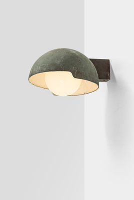 a close up of a light on a wall next to a wall