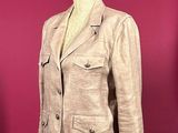 jacket on a mannequin stand against a red wall