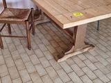 a wooden table and two chairs in a room