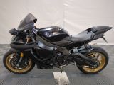 a picture of a black motorcycle parked on a checkered floor