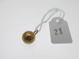 a close up of a bell on a string with a price tag
