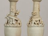 two vases that are sitting on a table
