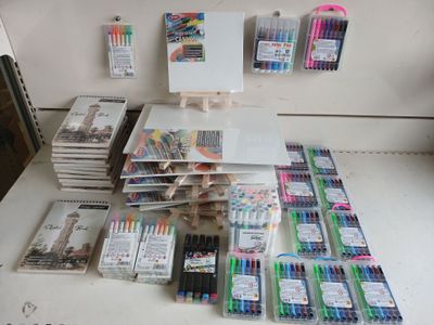 a table with a lot of pens and markers on it