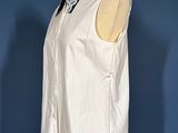 a white shirt with a black collar on a mannequin stand