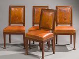 four chairs with leather upholstered backs and wooden legs
